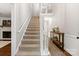 Carpeted staircase with white railing, leading to an upper level and a landing area at 9941 Heritage Oak Ln, Waxhaw, NC 28173