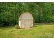 Storage shed with double doors and light-colored siding, set against a backdrop of trees at 9941 Heritage Oak Ln, Waxhaw, NC 28173