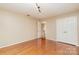 Bedroom with hardwood flooring and open door leading to a view of the interior staircase at 1000 Rudd Rd, Gastonia, NC 28054