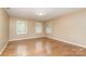Bright bedroom boasts hardwood floors and windows, creating an inviting atmosphere at 1000 Rudd Rd, Gastonia, NC 28054