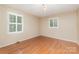 Cozy bedroom with hardwood flooring and natural light from two windows with white shutters at 1000 Rudd Rd, Gastonia, NC 28054