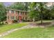 Charming brick two-story home with manicured lawn and a red front door at 1000 Rudd Rd, Gastonia, NC 28054