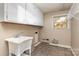 Unfinished laundry room with utility sink, ample cabinet space and natural light, ready for customization at 1000 Rudd Rd, Gastonia, NC 28054