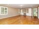 Inviting living room with hardwood floors, built-in shelves, and large windows with wooden shutters at 1000 Rudd Rd, Gastonia, NC 28054