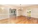 Elegant living room with hardwood floors, chandelier, and open access to other rooms at 1000 Rudd Rd, Gastonia, NC 28054