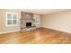 Inviting living room featuring a stone fireplace, hardwood floors, and bright windows at 1000 Rudd Rd, Gastonia, NC 28054