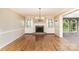 Spacious living room with hardwood floors, fireplace and built-in shelving, bathed in natural light at 1000 Rudd Rd, Gastonia, NC 28054