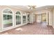 Bright sunroom featuring brick floors, arched windows, skylight, and a ceiling fan at 1000 Rudd Rd, Gastonia, NC 28054