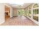 Charming sunroom with brick floors, large windows, skylight, and ceiling fan at 1000 Rudd Rd, Gastonia, NC 28054