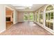 Charming sunroom with brick floors, many large windows, skylight, and ceiling fan at 1000 Rudd Rd, Gastonia, NC 28054