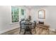Cozy dining area with a round table, modern chairs, and a large window with a view at 10528 Audubon Ridge Dr, Cornelius, NC 28031