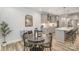 Dining area with a wooden bench, round table, and seamless transition into the modern kitchen at 10528 Audubon Ridge Dr, Cornelius, NC 28031