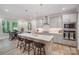Bright kitchen boasts stainless appliances, shaker cabinets, an island, and pendant lighting at 10528 Audubon Ridge Dr, Cornelius, NC 28031