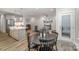Open-concept living space with an eat-in kitchen, neutral walls, and modern light fixtures at 10528 Audubon Ridge Dr, Cornelius, NC 28031