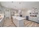 Open-concept living space with an eat-in kitchen, neutral walls, and modern light fixtures at 10528 Audubon Ridge Dr, Cornelius, NC 28031