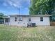 Backyard view of the home with a well-maintained lawn and an A/C unit at 109 Downing St, Troutman, NC 28166