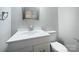 Cozy bathroom features a white vanity, a mirror, and a toilet at 109 Downing St, Troutman, NC 28166