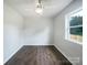 Minimalist bedroom featuring wood-look floors and ample natural light at 109 Downing St, Troutman, NC 28166