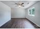 Bedroom featuring wood-look floors and a window overlooking the neighborhood at 109 Downing St, Troutman, NC 28166