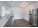 Bright living space with wood-look floors and stainless steel refrigerator at 109 Downing St, Troutman, NC 28166