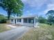 Rear exterior featuring a screened in porch and a mature tree at 109 Downing St, Troutman, NC 28166