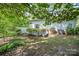 Backyard features a garden, patio, and views of the home's exterior surrounded by nature at 114 Walnut Creek Rd # 24, Belmont, NC 28012