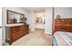 Bedroom with carpet, a dark wood dresser, and a mirror, leading to an ensuite bathroom at 114 Walnut Creek Rd # 24, Belmont, NC 28012
