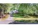 Exterior view of a home with a long driveway, surrounded by lush green trees at 114 Walnut Creek Rd # 24, Belmont, NC 28012
