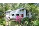 Modern home featuring a red front door, lots of window space, and landscaped bushes and trees at 114 Walnut Creek Rd # 24, Belmont, NC 28012