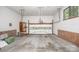 Spacious garage with red brick trim, features a white garage door and side door at 114 Walnut Creek Rd # 24, Belmont, NC 28012