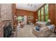 Living room with brick fireplace, wood paneling, and plenty of window space for natural light at 114 Walnut Creek Rd # 24, Belmont, NC 28012