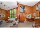 Spacious living room with wood paneling, lots of windows, and carpeted floors at 114 Walnut Creek Rd # 24, Belmont, NC 28012