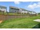 View of backyards, featuring green lawns and fence lines, showcasing neighborhood outdoor living spaces at 119 Longwood Rd # 62, Mooresville, NC 28115