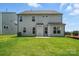 Backyard view of a gray two-story home, showcasing a lush lawn and partial privacy fence at 119 Longwood Rd # 62, Mooresville, NC 28115