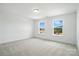 Bright bedroom with two windows, neutral carpet, and ample space for furniture at 119 Longwood Rd # 62, Mooresville, NC 28115