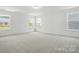 Bright, spacious bedroom featuring three large windows and neutral carpet at 119 Longwood Rd # 62, Mooresville, NC 28115
