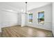 Formal dining room with wainscoting, modern light fixture, and large windows at 119 Longwood Rd # 62, Mooresville, NC 28115