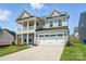 Charming two-story home with a welcoming front porch and attached two-car garage at 119 Longwood Rd # 62, Mooresville, NC 28115