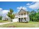 Two-story home with a cozy front porch and well-manicured lawn at 119 Longwood Rd # 62, Mooresville, NC 28115