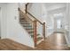 Bright foyer boasts hardwood floors and a staircase with wood and black iron accents at 119 Longwood Rd # 62, Mooresville, NC 28115