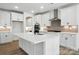 Bright kitchen featuring an island, stainless appliances, and hardwood floors at 119 Longwood Rd # 62, Mooresville, NC 28115