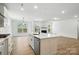 Bright, open kitchen with a large island, stainless steel appliances, and a view to the living area at 119 Longwood Rd # 62, Mooresville, NC 28115