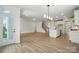 Open floor plan with kitchen island, hardwood floors, and views to the entryway and staircase at 119 Longwood Rd # 62, Mooresville, NC 28115