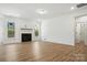 Inviting living room with a shiplap fireplace, wood floors, and lots of natural light at 119 Longwood Rd # 62, Mooresville, NC 28115