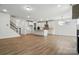 Open living space featuring an island kitchen, white cabinets, and hardwood floors at 119 Longwood Rd # 62, Mooresville, NC 28115