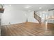 Open living space with wood floors, staircase, and white trim at 119 Longwood Rd # 62, Mooresville, NC 28115