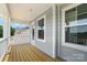 Covered porch featuring wood flooring and white railings, providing a cozy outdoor space at 119 Longwood Rd # 62, Mooresville, NC 28115