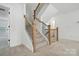 Bright staircase with wooden handrails and black metal balusters offers a modern touch to this well-lit home at 119 Longwood Rd # 62, Mooresville, NC 28115