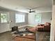 Bright living room with fireplace, hardwood floors, chair, area rug, ceiling fan, and windows at 13131 601 S Hwy, Midland, NC 28107