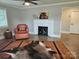 Comfortable living room with fireplace, ceiling fan, hardwood floors, chair and area rug at 13131 601 S Hwy, Midland, NC 28107